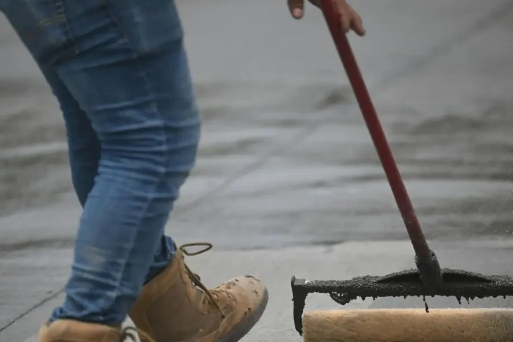Man sealing concrete