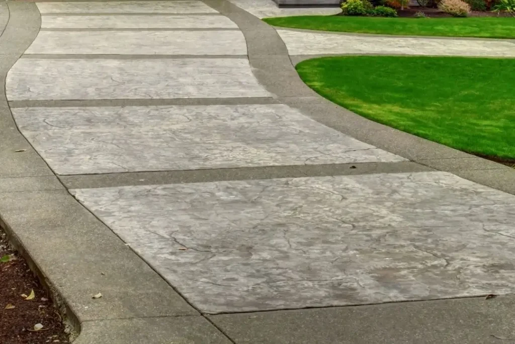 plain concrete with decorative inlay driveway design